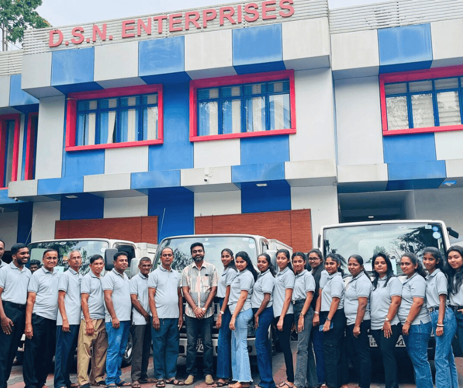 D.S.N. Enterprises full staff team in pale blue polos outside their office