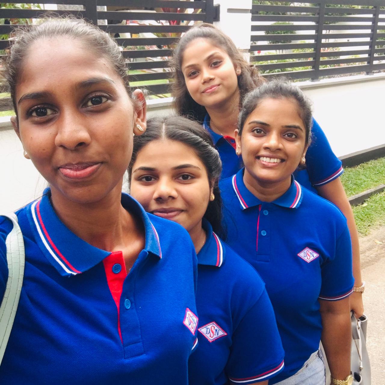 D.S.N. team ladies in royal blue polos with embroidered DSN crest
