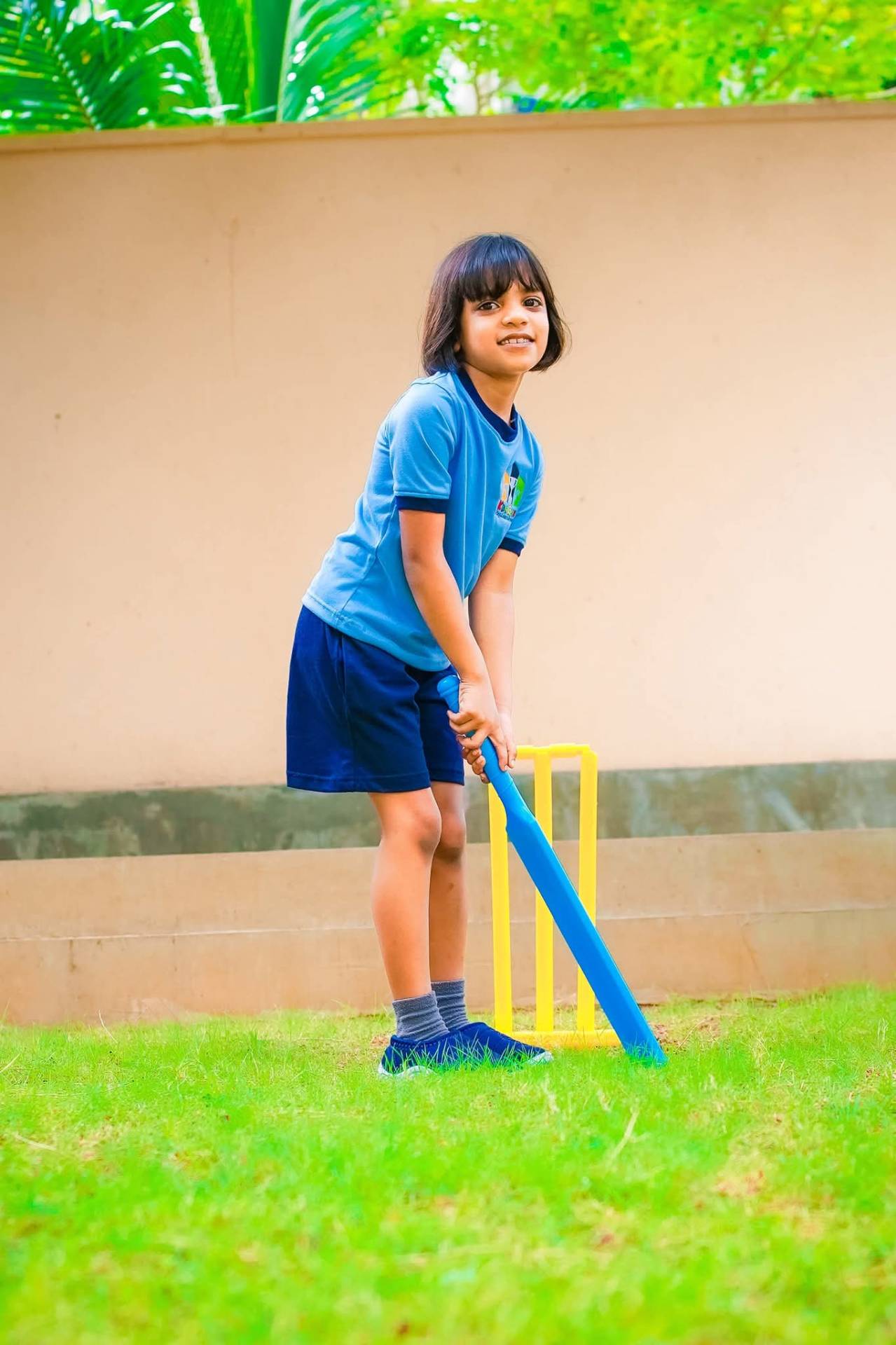 Kids Club pre-schooler playing cricket in sky blue Mezzo ringer tee with embroidered crest