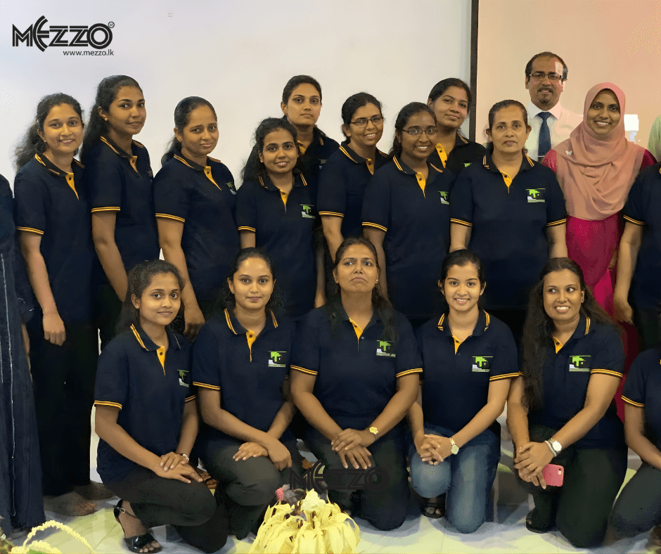 Mezzo Clothing in-house team in navy polos with yellow trim and embroidered logo