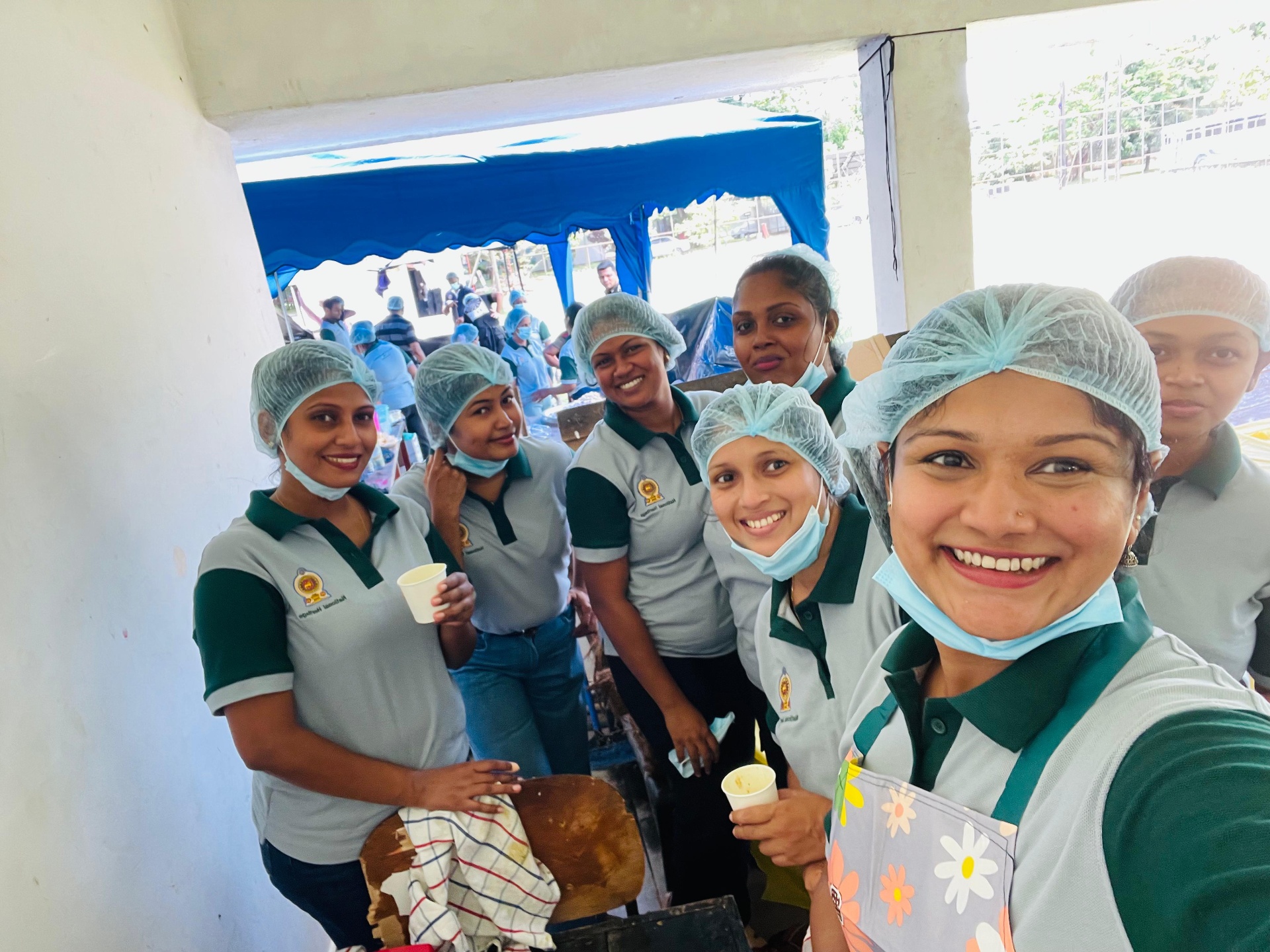 Ministry of Buttala Region kitchen volunteers in pale grey and green Mezzo polos