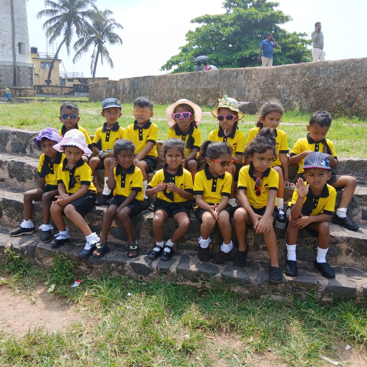 Wisdom Kids Kindergarten children in yellow and black polo uniforms on a field trip to Galle lighthouse
